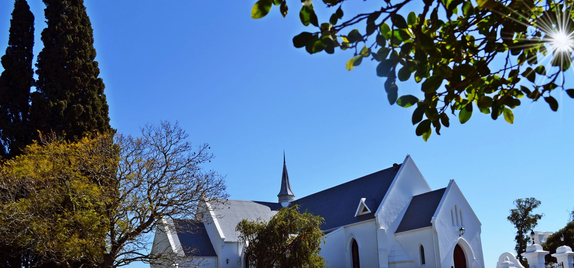 The white church building at Durbanville against a deep blue sky.